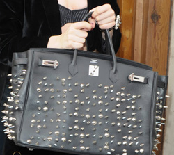 Lady Gaga holds a handbag she studded herself. Photo from Purse Blog.